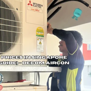 Aircon technician using pressure gauge manifold set to check refrigerant level on outdoor compressor unit in Singapore HDB flat