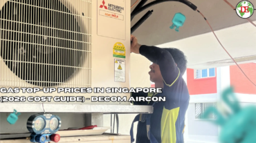 Aircon technician using pressure gauge manifold set to check refrigerant level on outdoor compressor unit in Singapore HDB flat