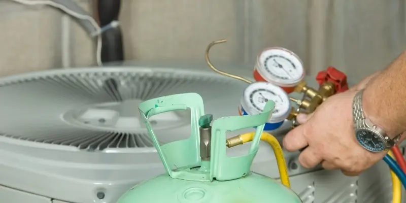 Decom Aircon technician vacuuming and recharging aircon refrigerant with digital scale Singapore