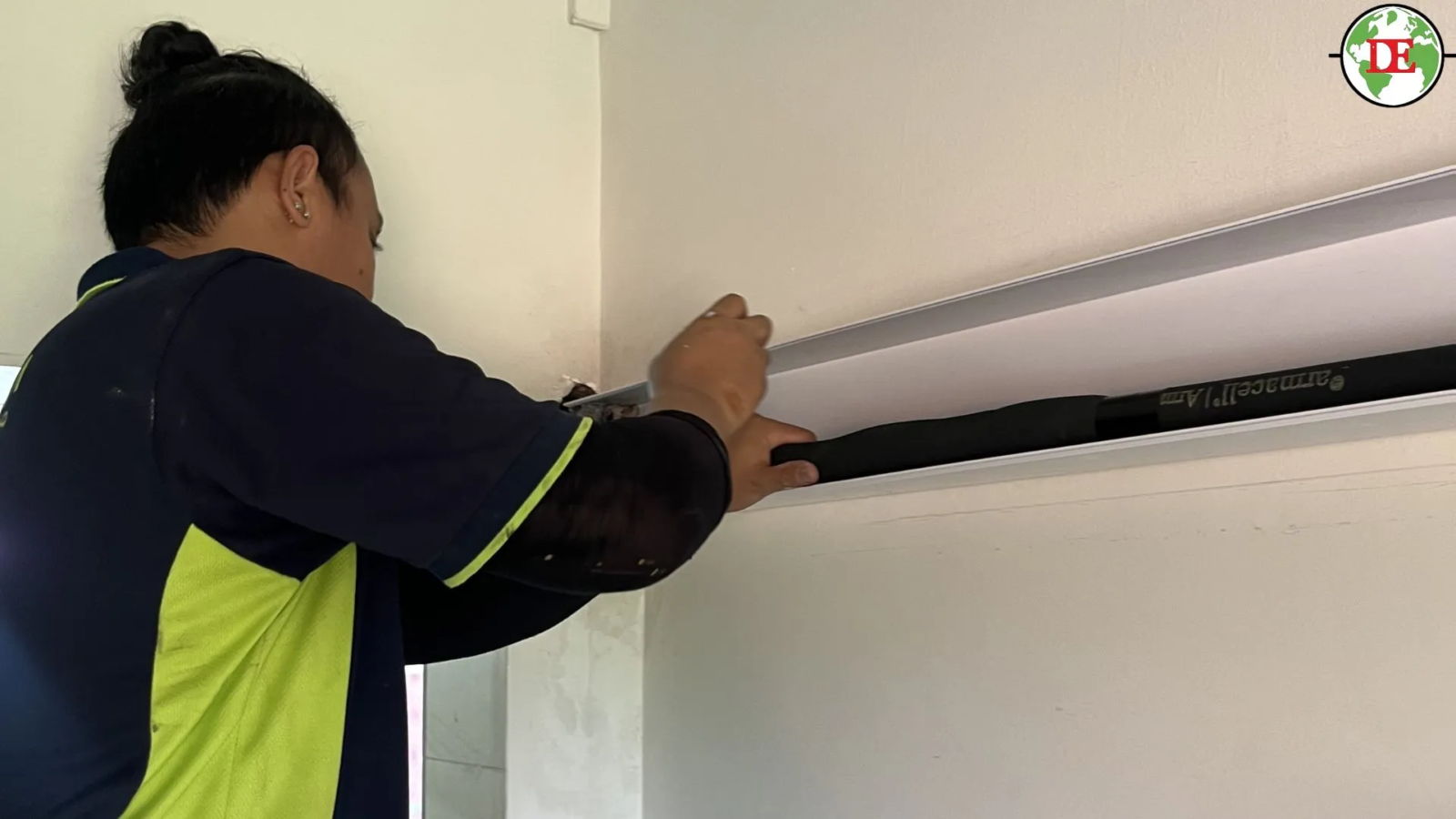 PVC aircon trunking casing covering copper pipes on HDB wall Singapore