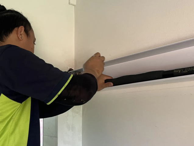 PVC aircon trunking casing covering copper pipes on HDB wall Singapore