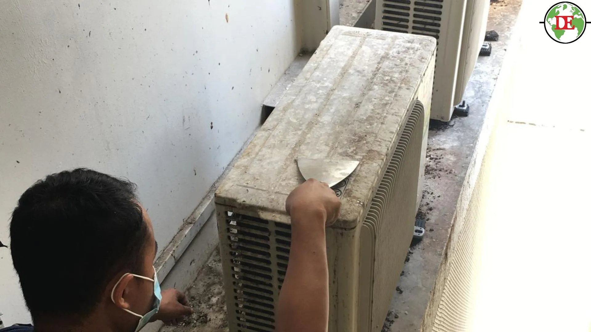 Technician cleaning outdoor aircon unit coils for compressor maintenance Singapore